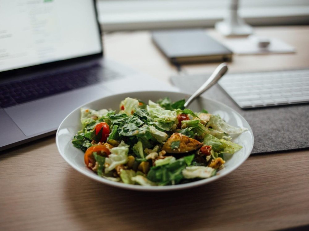 salad on white ceramic bowl on top of table near laptop